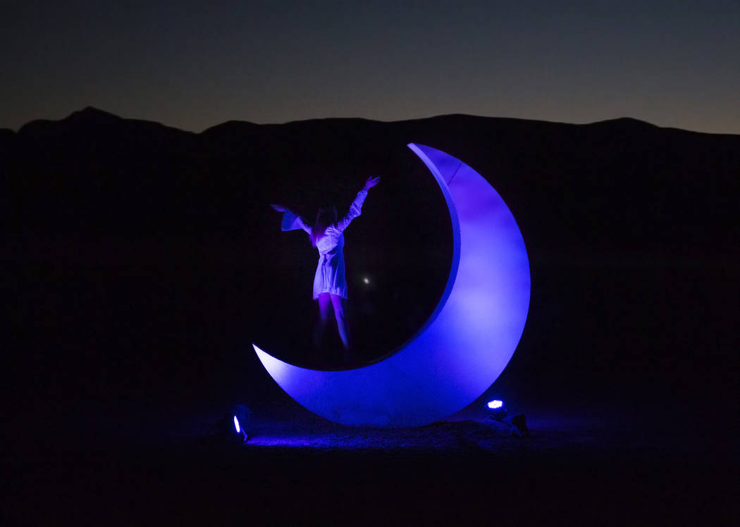 Geli Yescas stands on a giant moon sculpture during the RiSE festival on Sunday, Oct. 6, 2019, ...