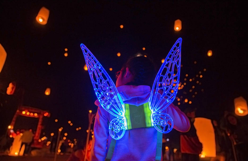Keira Wang, 5, from Rosemead, Calif., watches lanterns be released during the RiSE festival on ...