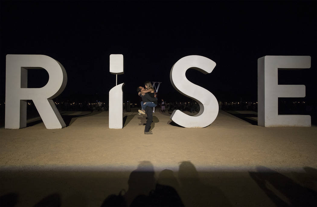 Amy Dominguez, right, embraces Adam Paz during the RiSE festival on Sunday, Oct. 6, 2019, near ...