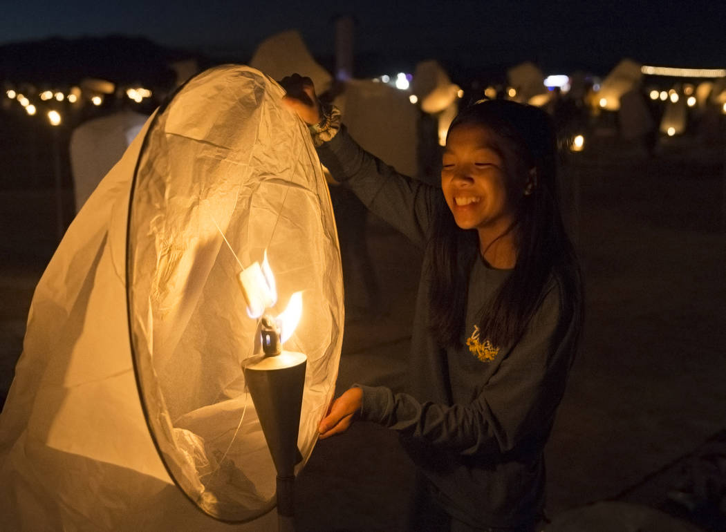 Emma Doan, right, 13, from Orange County, Calif., fills her lantern with hot air during the RiS ...