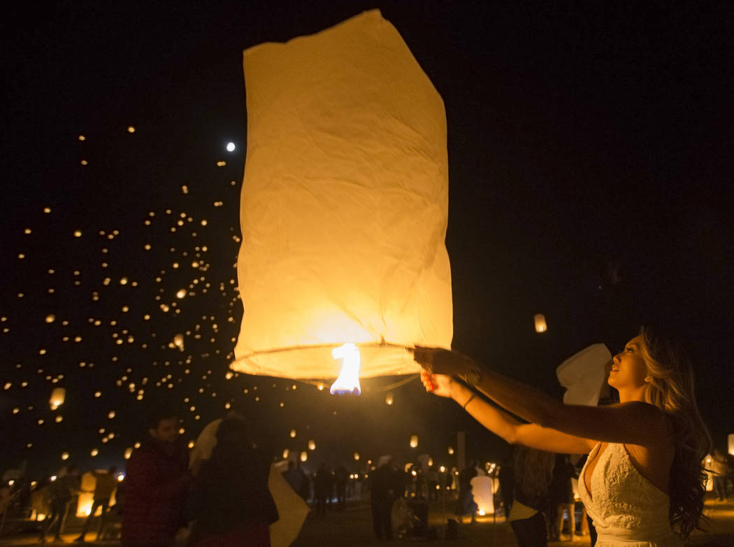 Vi Pham from Seattle releases her lantern during the RiSE festival on Sunday, Oct. 6, 2019, nea ...