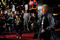 Comedian Rip Taylor throws confetti on photographers at the premiere of the film "Jackass ...