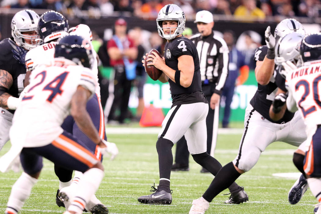 Oakland Raiders quarterback Derek Carr (4) drops back to pass during the first half of an NFL g ...