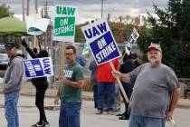 John Kirk, right, a 20-year-employee, pickets with co-workers outside the General Motors Fabric ...