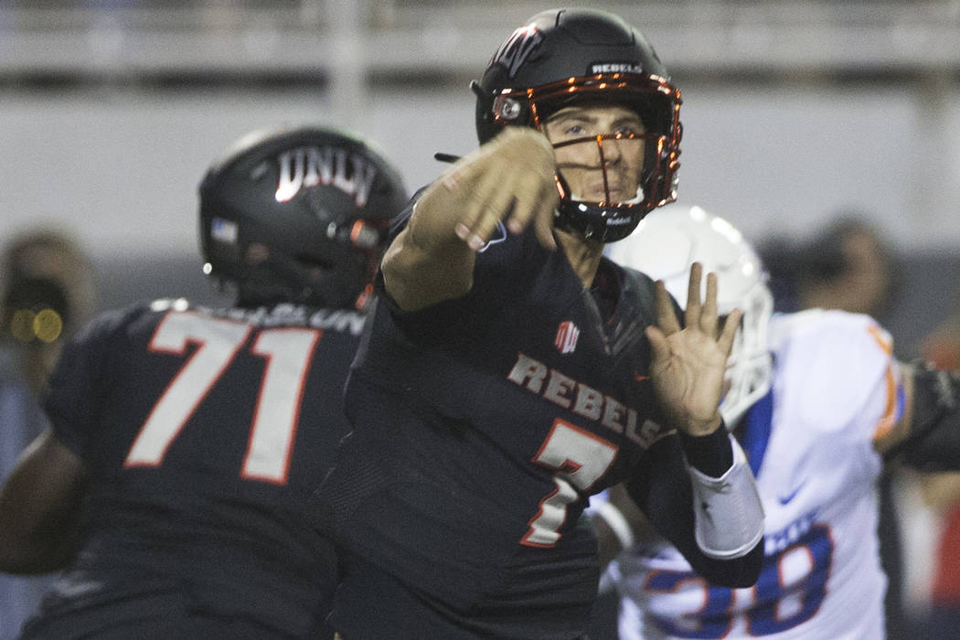 UNLV Rebels quarterback Kenyon Oblad (7) makes a sideline pass before the rush from Boise State ...