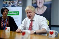 Britain's Prime Minister Boris Johnson speaks to health professionals as he visits Watford Gene ...