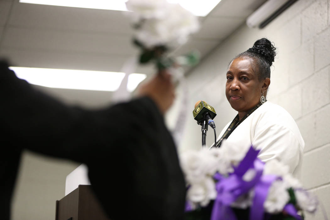 Las Vegas Metropolitan Police Department victims advocate Regina Porter watches as a flower wit ...