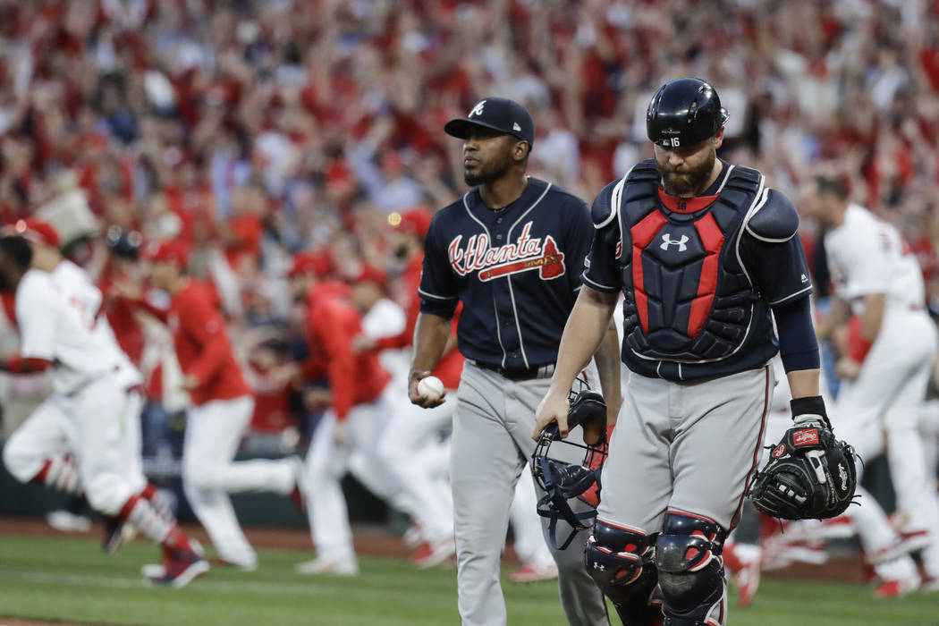 Atlanta Braves' Julio Teheran and catcher Brian McCann walk to the dugout after St. Louis Cardi ...