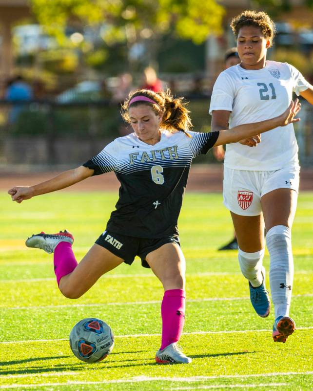 Faith Lutheran's Camille Longabardi (6, left) winds up on the ball as Arbor View's Tiana Beaver ...
