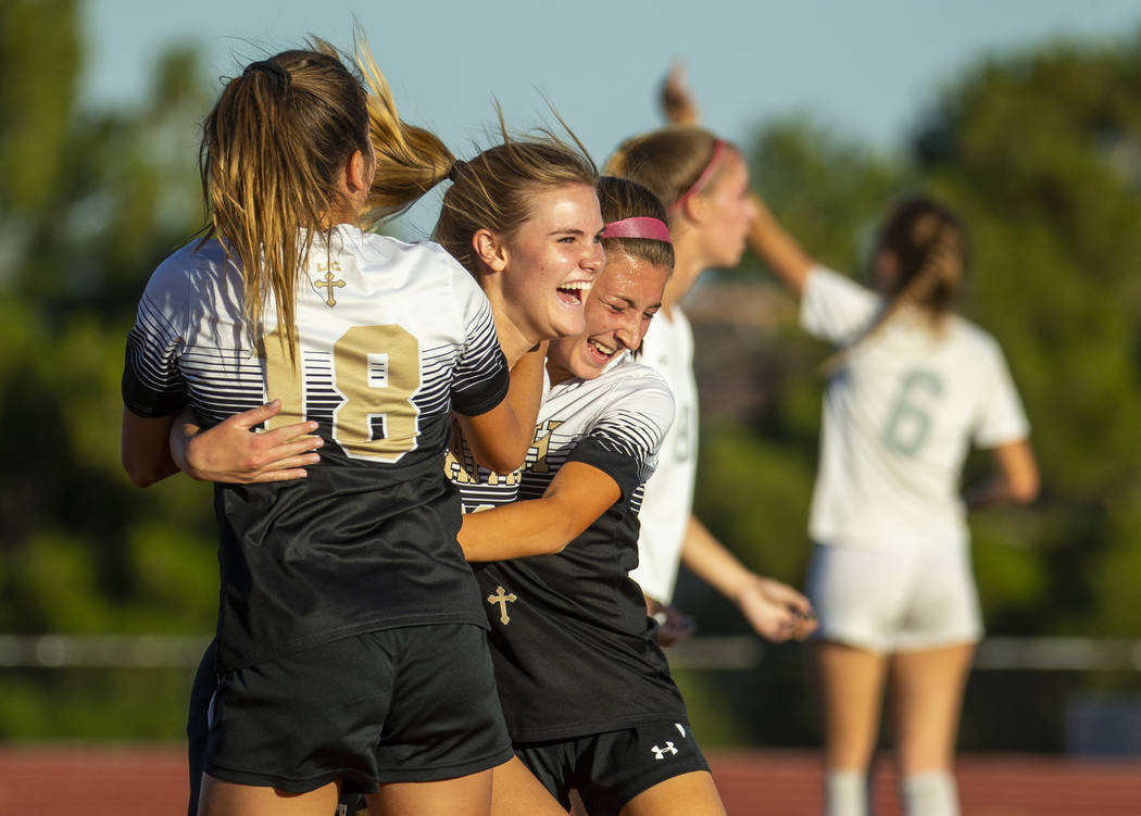Faith Lutheran's Amelia McManus (20, center) celebrates a goal with teammates Addy Radwanski (1 ...
