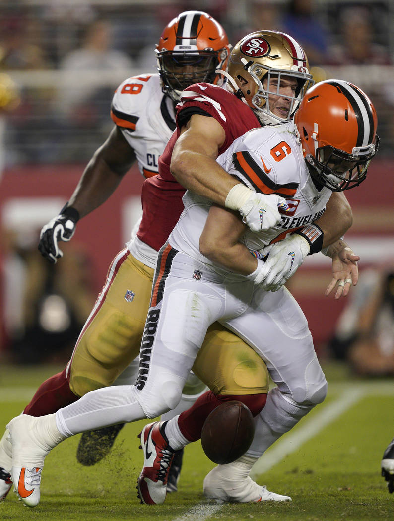 San Francisco 49ers defensive end Nick Bosa, center, sacks and forces a fumble by Cleveland Bro ...