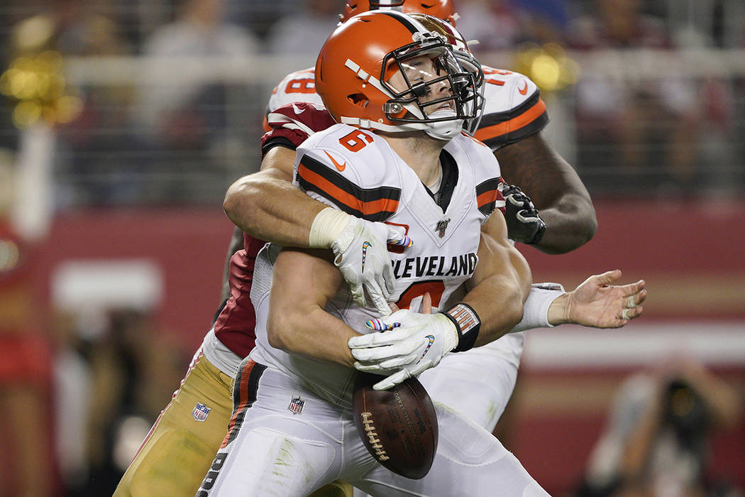 San Francisco 49ers defensive end Nick Bosa, center, sacks and forces a fumble by Cleveland Bro ...