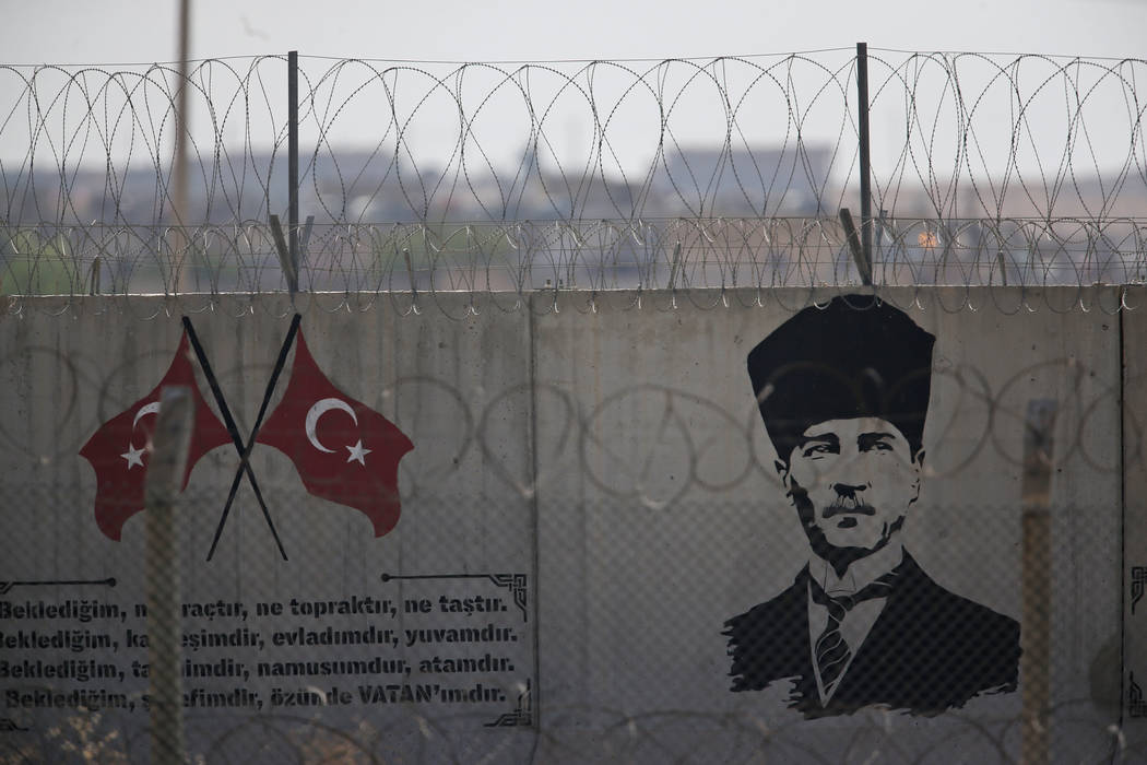 A graffiti of modern Turkey's founder Mustafa Kemal Ataturk is seen on the Turkish side of the ...