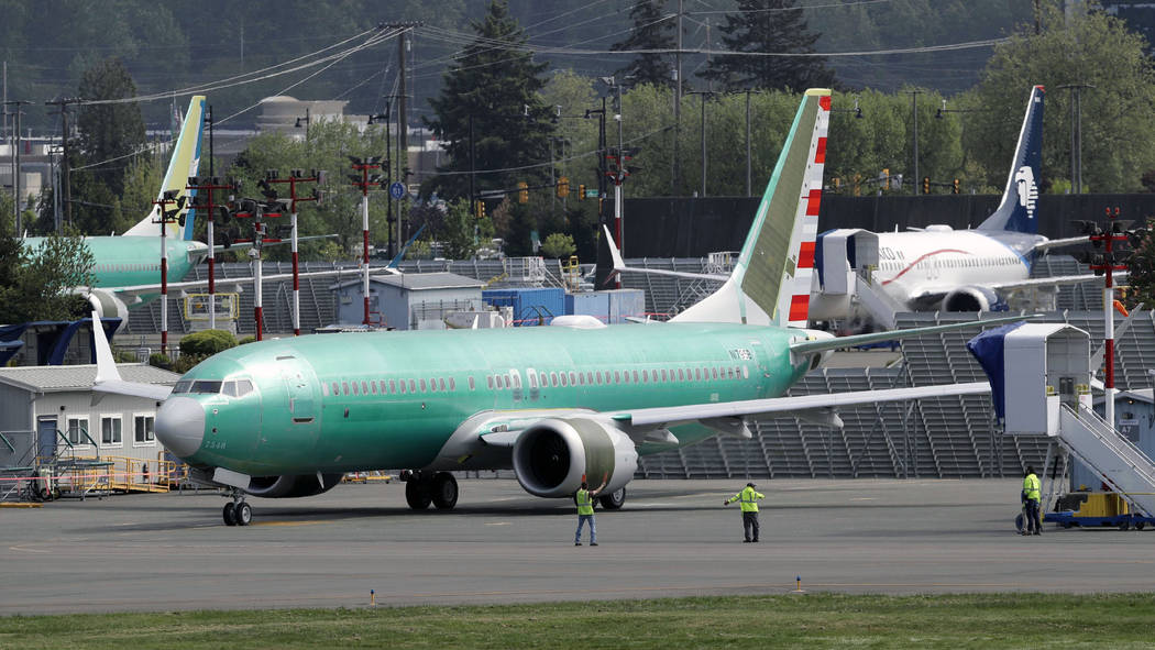 FILE - In this Wednesday, May 8, 2019 file photo, workers stand near a Boeing 737 MAX 8 jetline ...