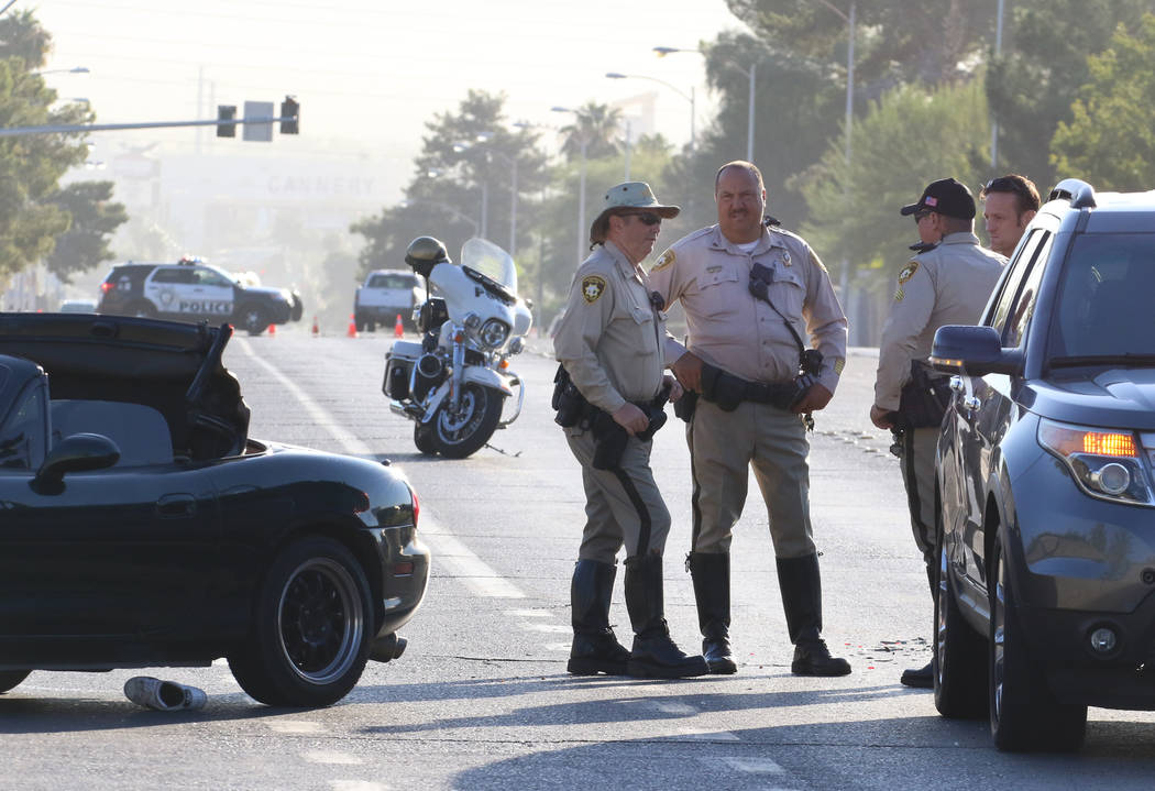 Las Vegas police investigate a serious injury crash at East Harmon Avenue and South Sandhill Ro ...