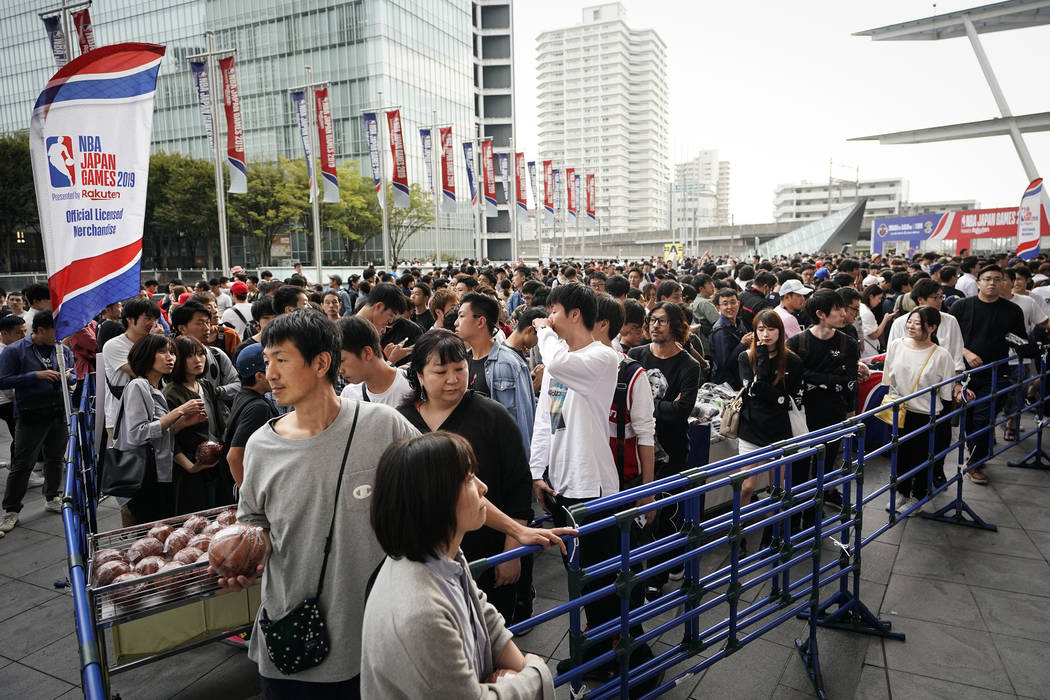 Fans wait in line to purchase team merchandise outside Saitama Super Arena in Saitama, near Tok ...