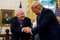 President Donald Trump shakes hands with former Attorney General Edwin Meese after presenting h ...