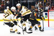 Boston Bruins' Zdeno Chara (33) and Golden Knights' Brandon Pirri (73) look for the puck during ...