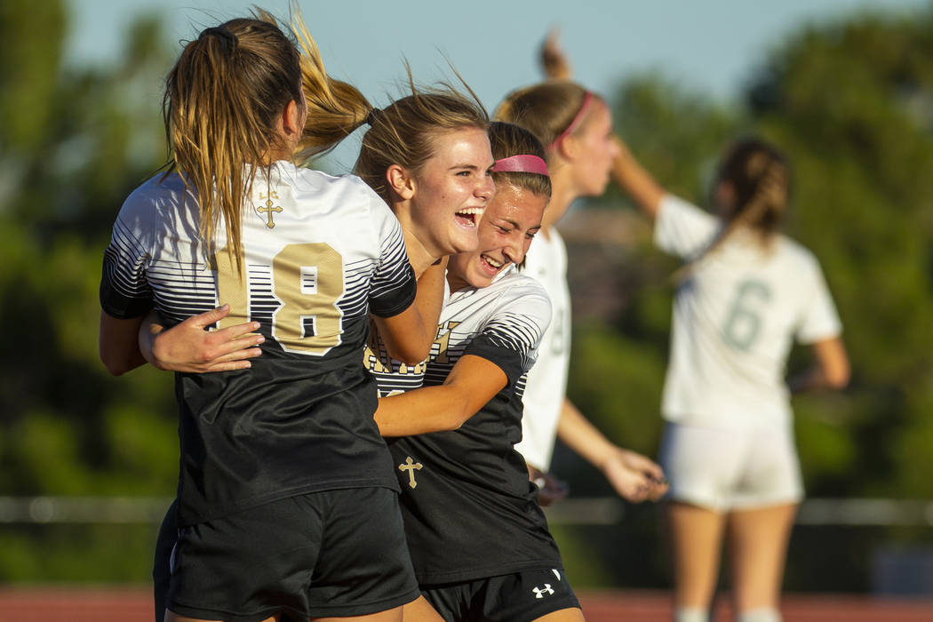 Faith Lutheran's Amelia McManus (20, center) celebrates a goal with teammates Addy Radwanski (1 ...