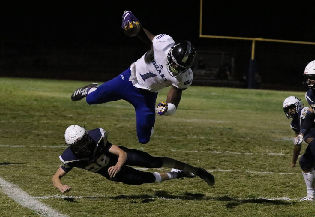 Desert Pines High's wide receiver Darnell Washington (1) avoids a tackle from Foothill High's&# ...