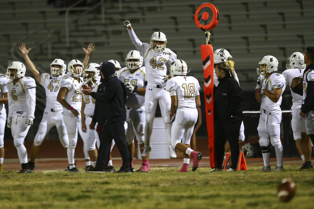 Faith Lutheran players celebrate as they lead during the second half of a football game at Cent ...