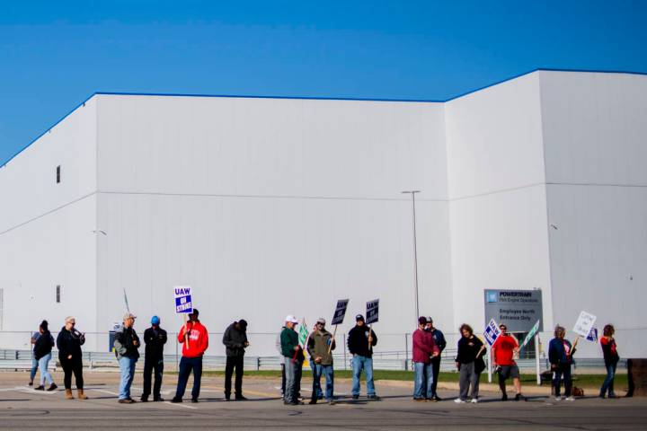 General Motors' Flint Assembly Plant employees line the street with picket signs during the nat ...