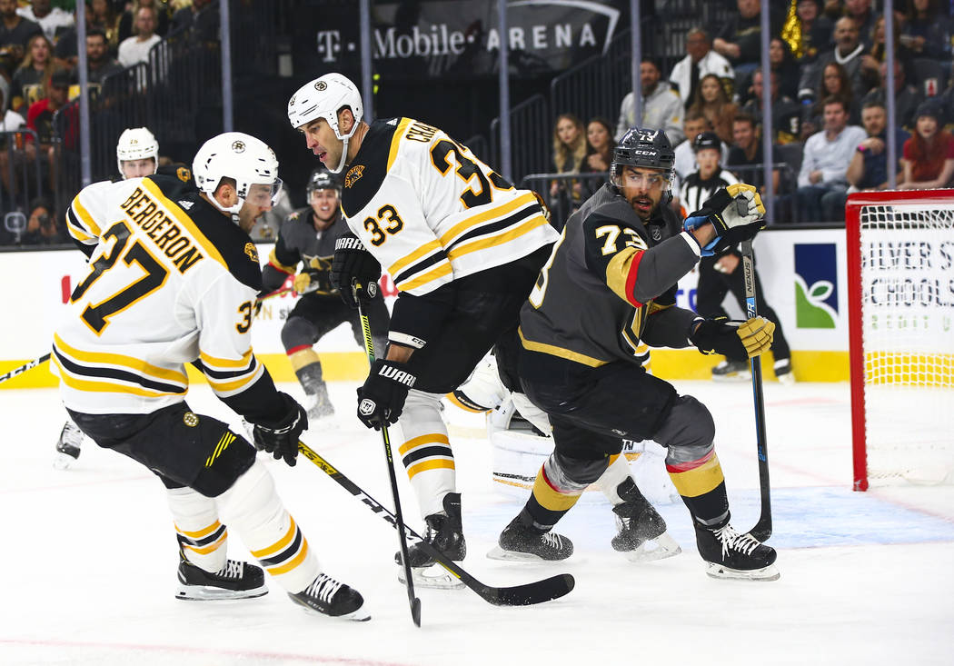 Boston Bruins' Zdeno Chara (33) and Golden Knights' Brandon Pirri (73) look for the puck during ...