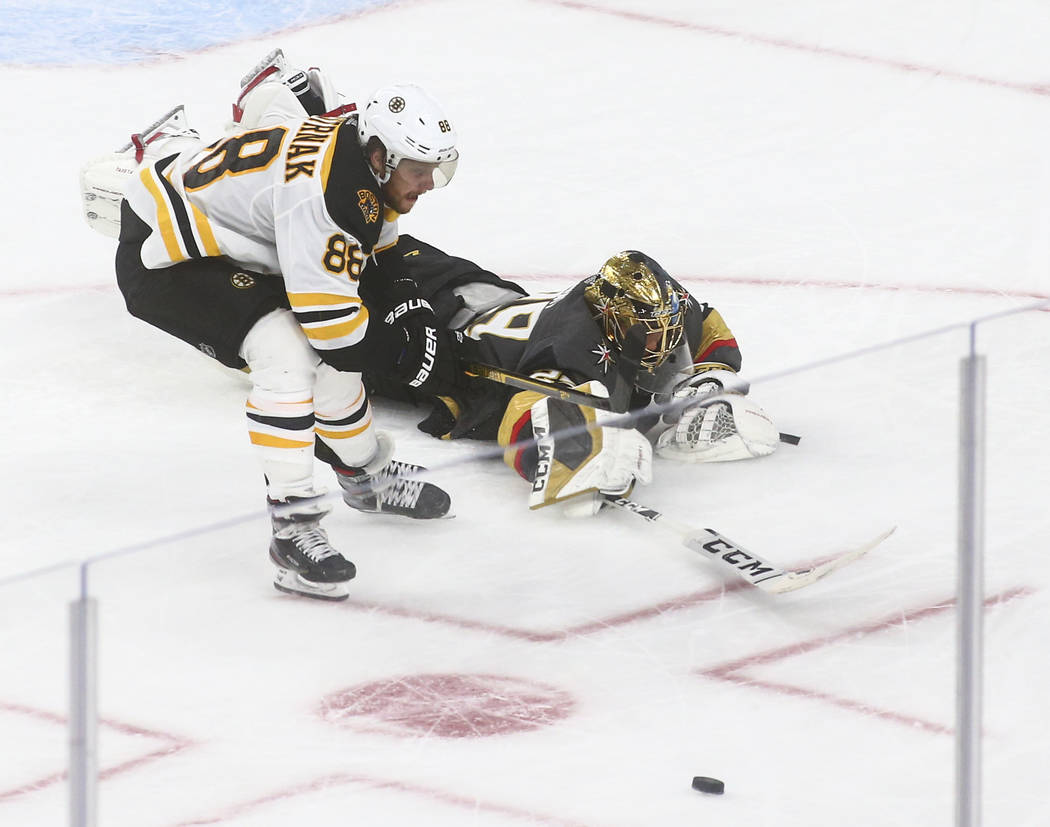 Golden Knights goaltender Marc-Andre Fleury (29) blocks a shot in front of Boston Bruins' David ...