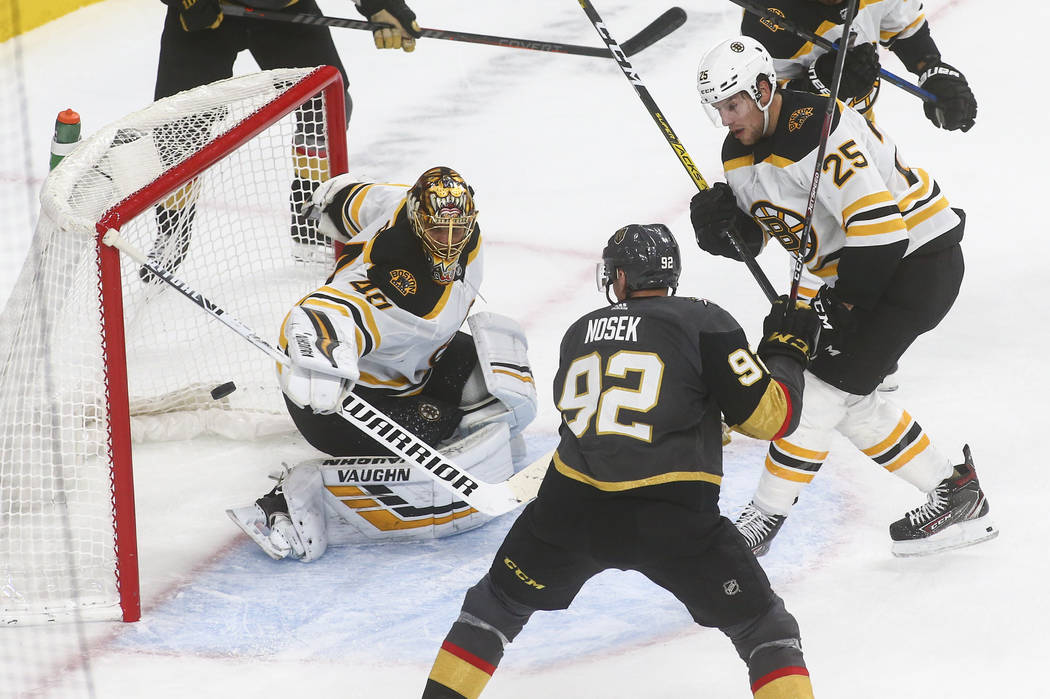 Boston Bruins goaltender Tuukka Rask (40) blocks a shot in front of Golden Knights' Tomas Nosek ...
