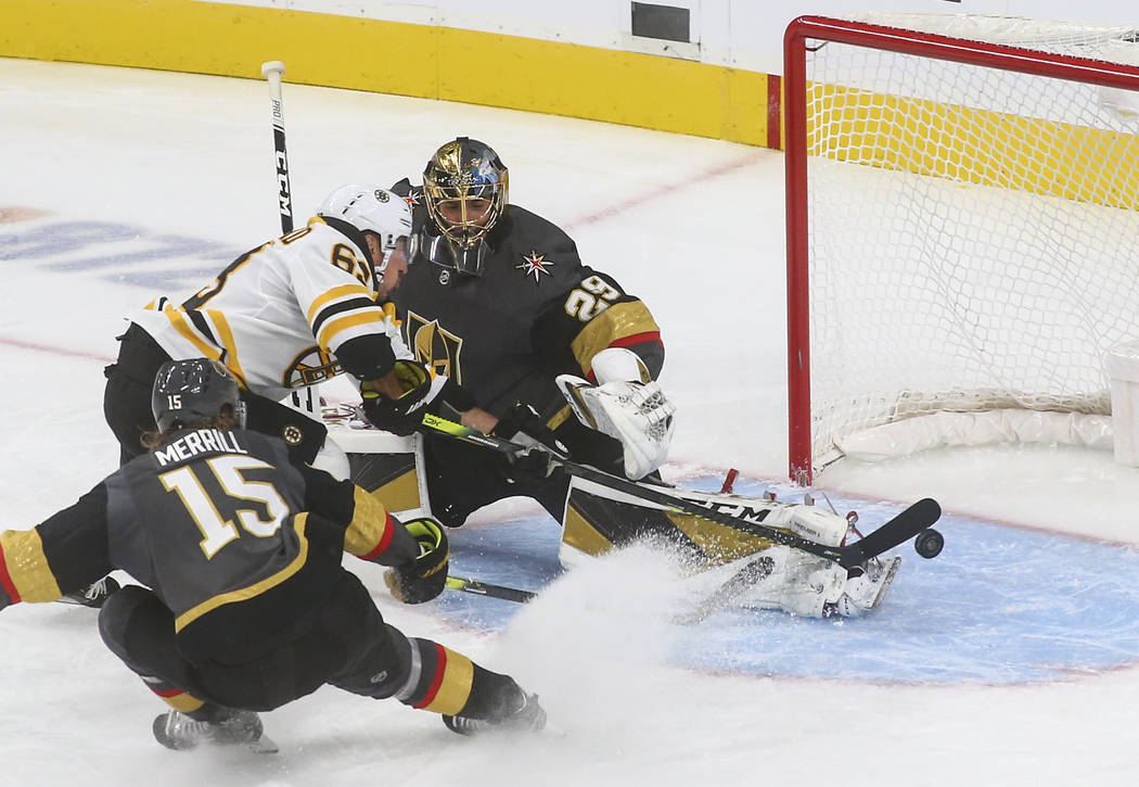 Golden Knights goaltender Marc-Andre Fleury (29) blocks a shot from Boston Bruins' Brad Marchan ...