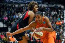 Connecticut Sun's Alyssa Thomas, front, drives past Washington Mystics' Tianna Hawkins during t ...