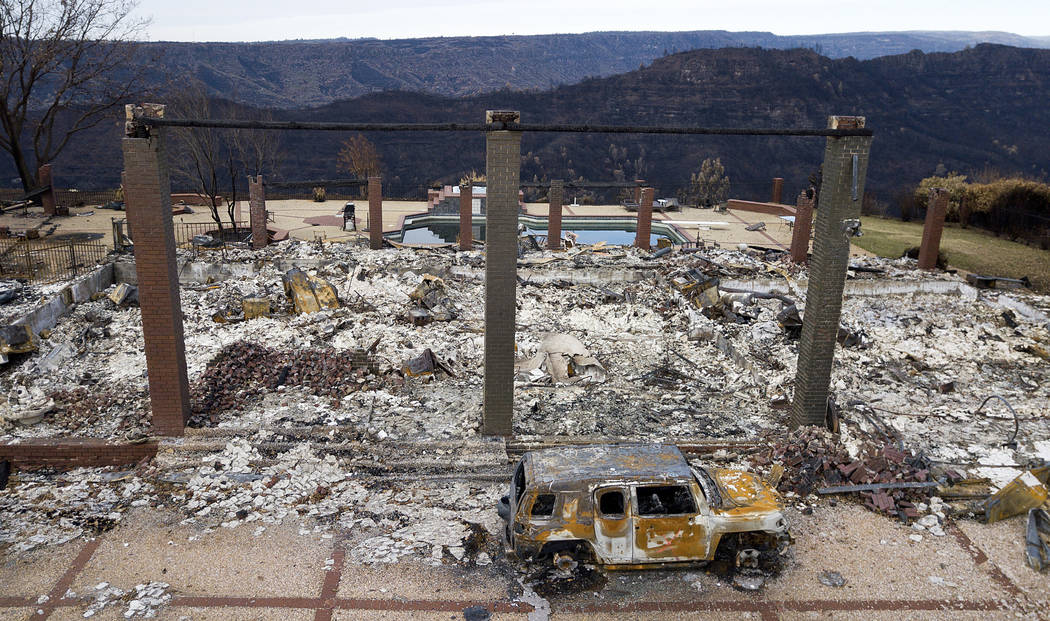 In this Dec. 3, 2018, file photo, a vehicle rests in front of a home leveled by the Camp Fire i ...