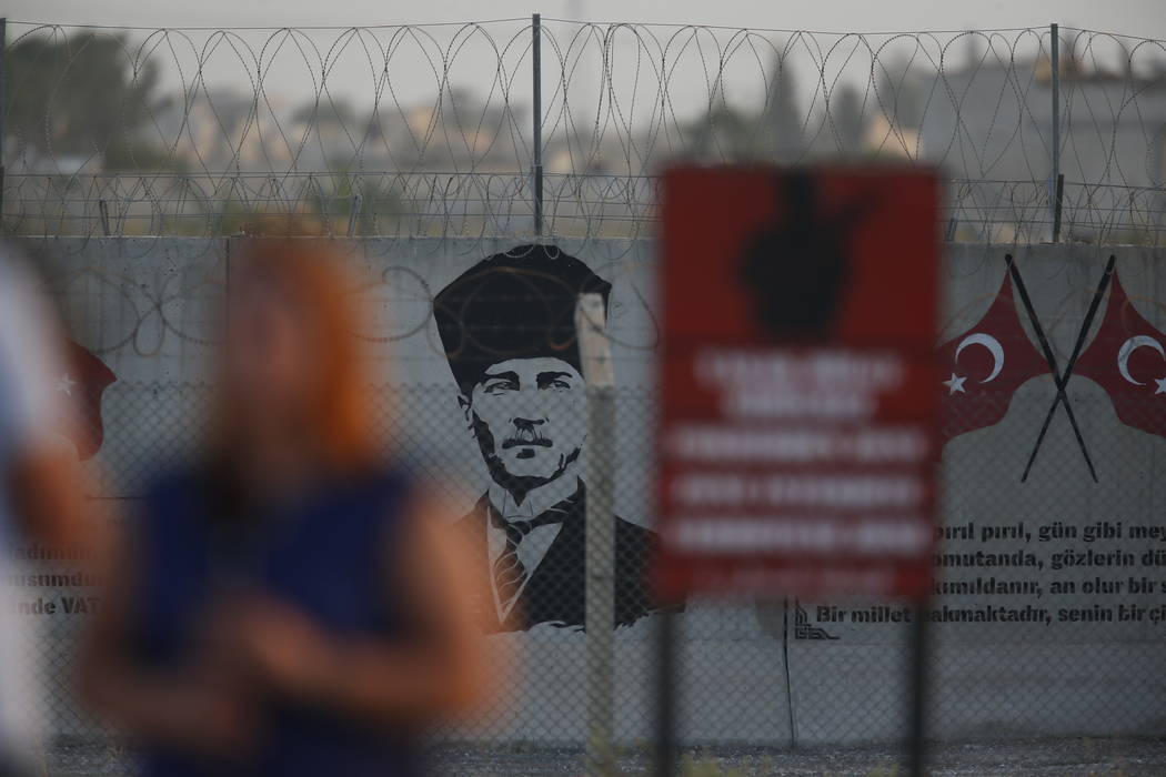 A graffiti of modern Turkey's founder Mustafa Kemal Ataturk is seen on the Turkish side of the ...