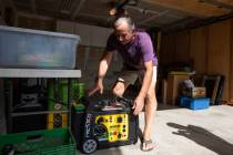 Joe Wilson pulls his generator out in the garage of his home, which is in an area that is expec ...