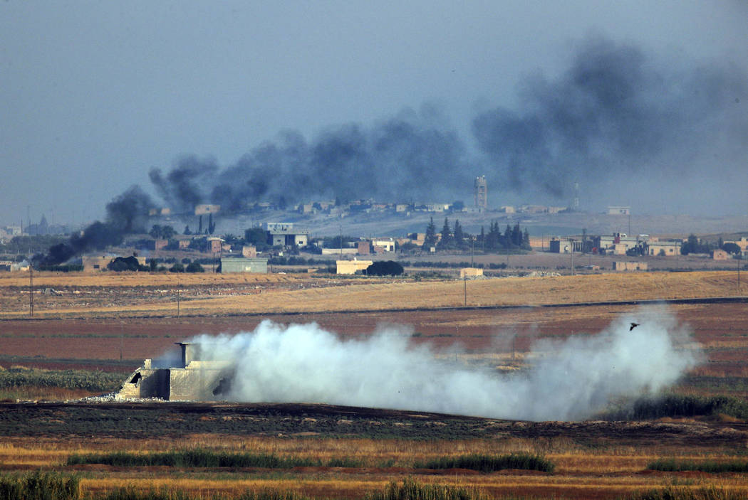 In this photo taken from the Turkish side of the border between Turkey and Syria, in Akcakale, ...