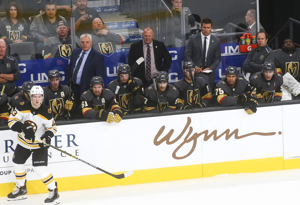 Golden Knights head coach Gerard Gallant, center, looks on during the third period of an NHL ho ...