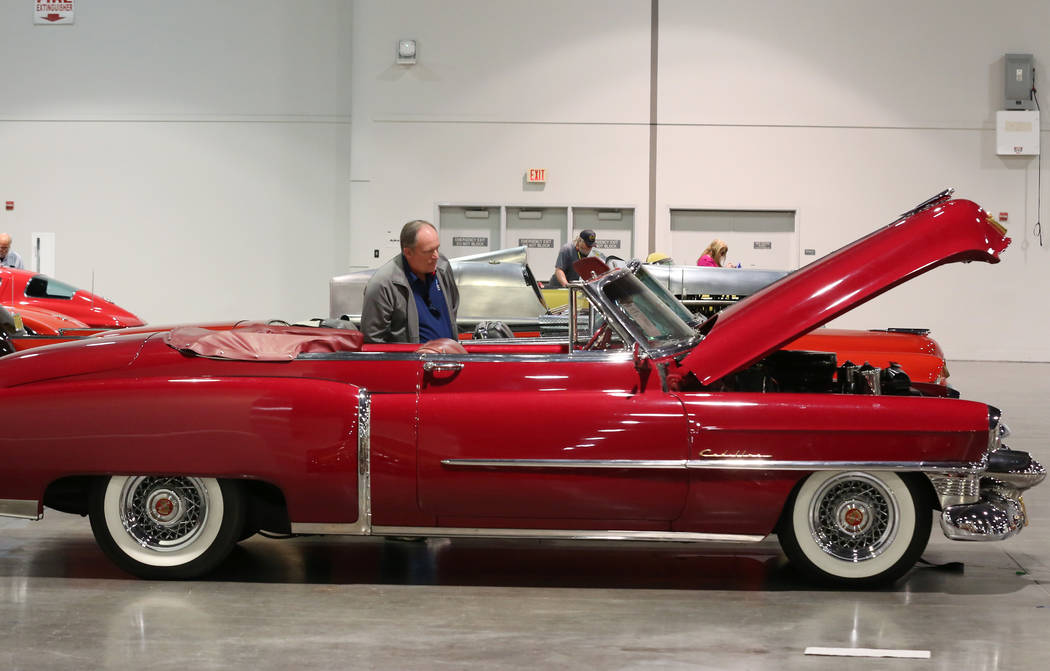 Joe Haduch checks out a 1953 Cadillac Series 62 Convertible during the Mecum Car Auction at the ...