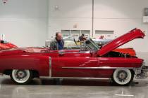 Joe Haduch checks out a 1953 Cadillac Series 62 Convertible during the Mecum Car Auction at the ...