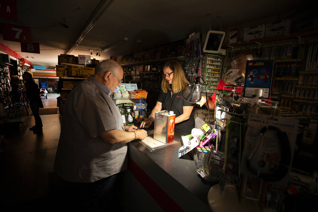 Tom Hyde, left, buys a can of fuel for his Coleman camp stove from Kim Scheffer at a Village Tr ...