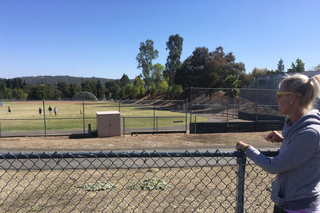 Erika Lippsmeyer watches her sons play football with other children at a playground because sch ...