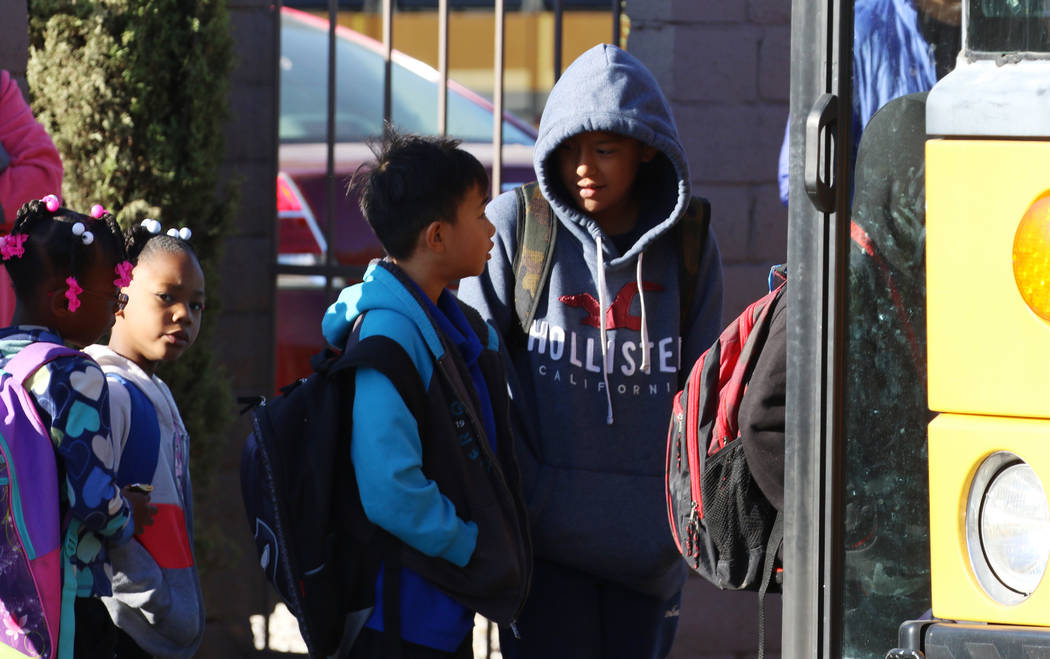 Students are bundled up as they board their school bus at West Viking Road in Las Vegas, Thursd ...