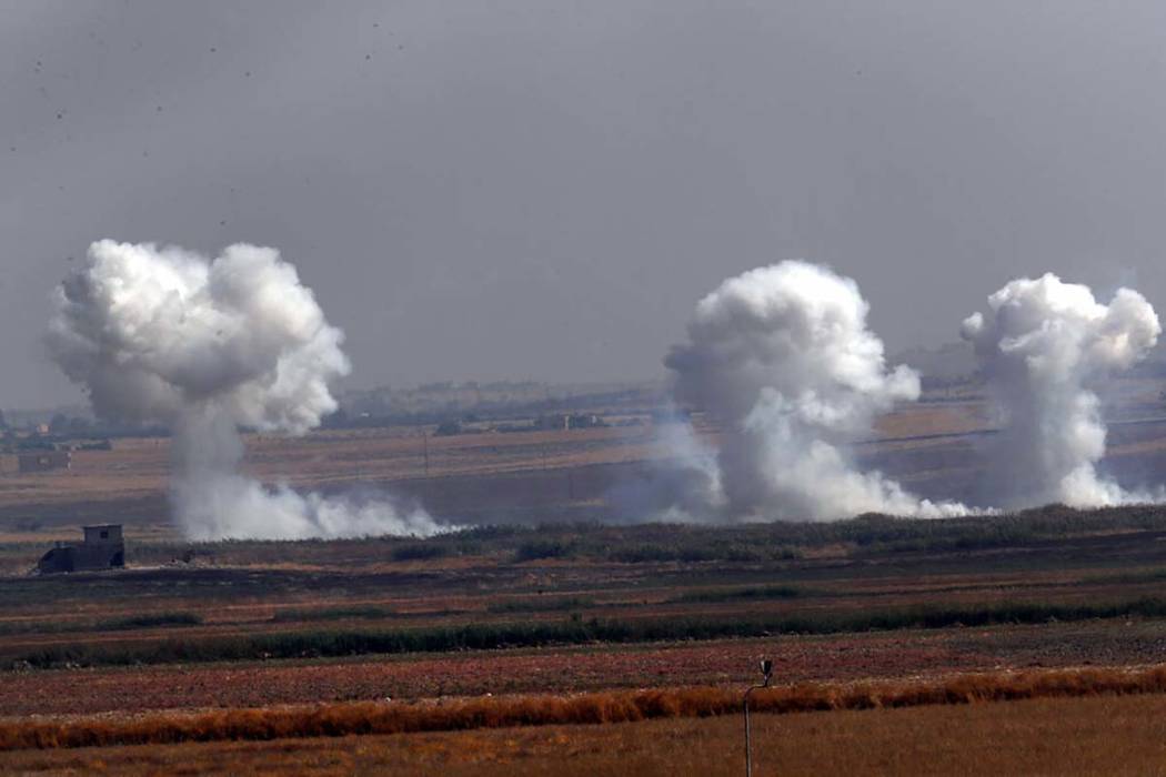 In this photo taken from the Turkish side of the border between Turkey and Syria, in Akcakale, ...