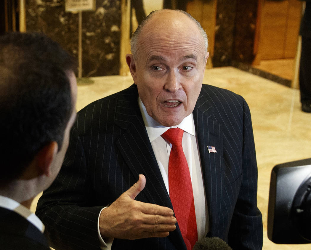 FILE - In this Jan. 12, 2017, file photo, former New York City Mayor Rudy Giuliani talks with r ...