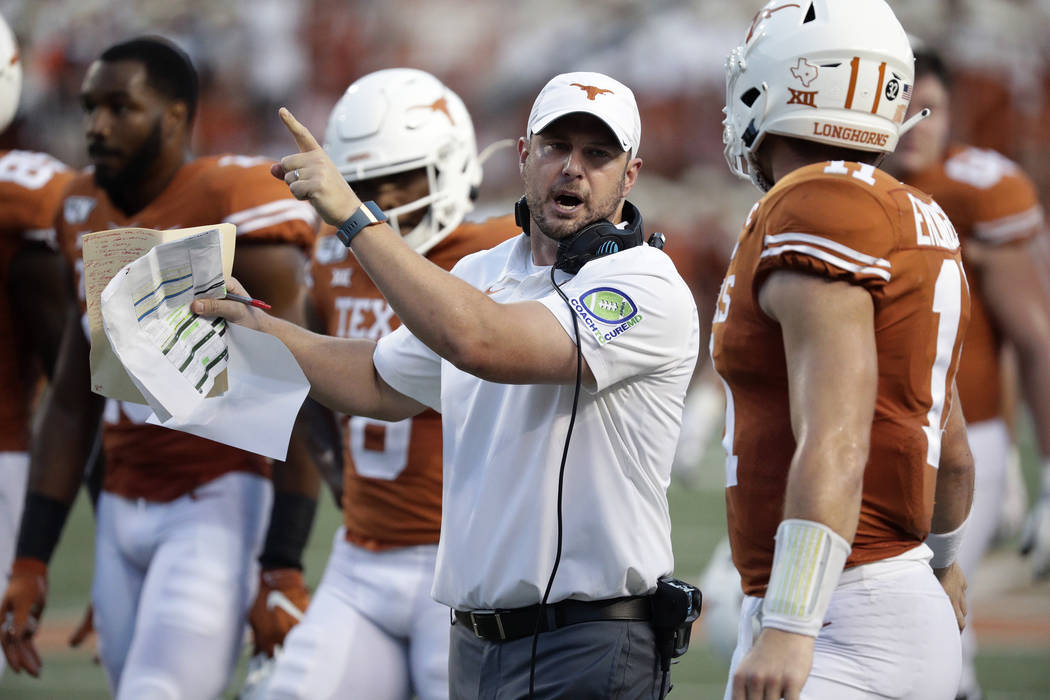 Texas head coach Tom Herman, left, and Texas quarterback Sam Ehlinger (11) during the first hal ...