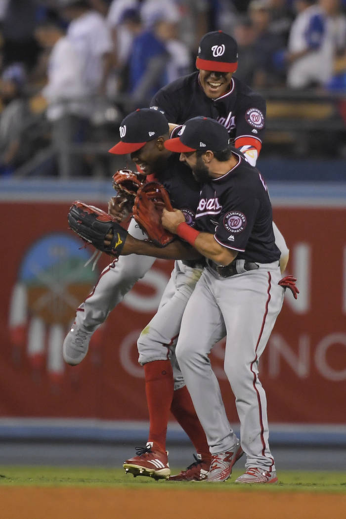 Washington Nationals celebrate after the team's 7-3 win in Game 5 of a baseball National League ...