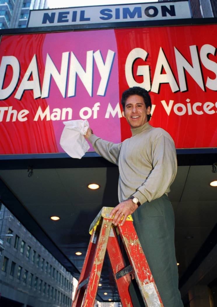 In this Sept. 27, 1995 file photo, Danny Gans dusts off the marquee of New York's Neil Simon T ...