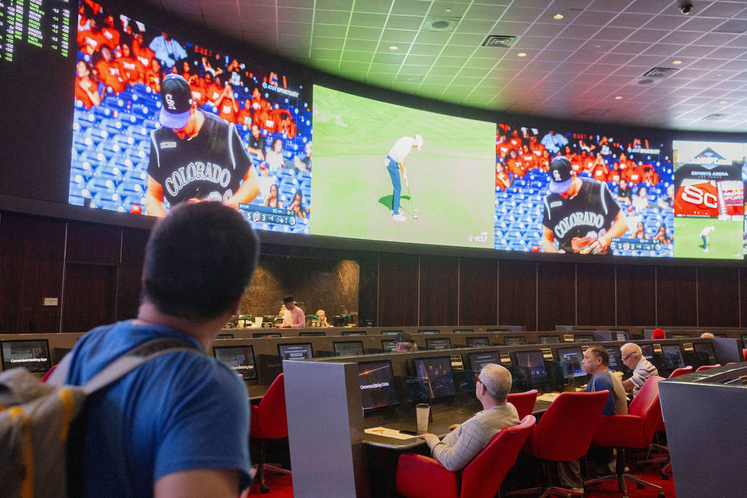 Betters watch live sports at the CG Technology sports book at the newly renovated Palms in Las ...