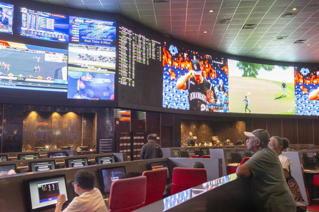 Betters watch live sports at the CG Technology sports book at the newly renovated Palms in Las ...