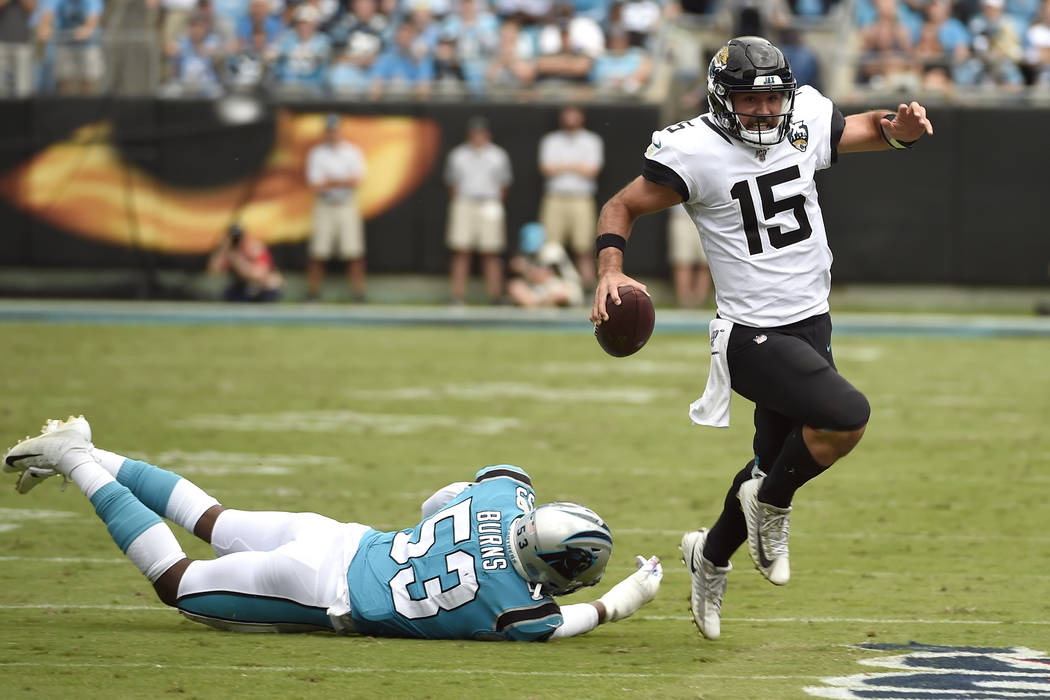 Jacksonville Jaguars quarterback Gardner Minshew (15) runs while Carolina Panthers linebacker B ...