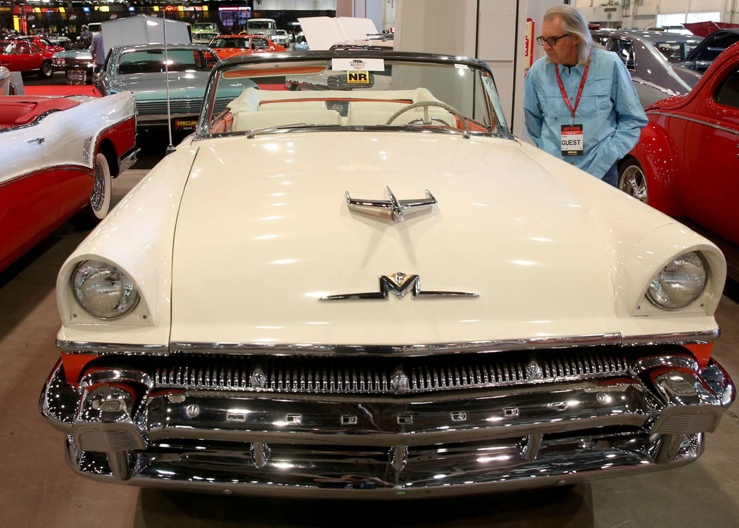 Earl Brady of Las Vegas checks out a 1956 Mercury Montclair convertible that will be in the Fri ...